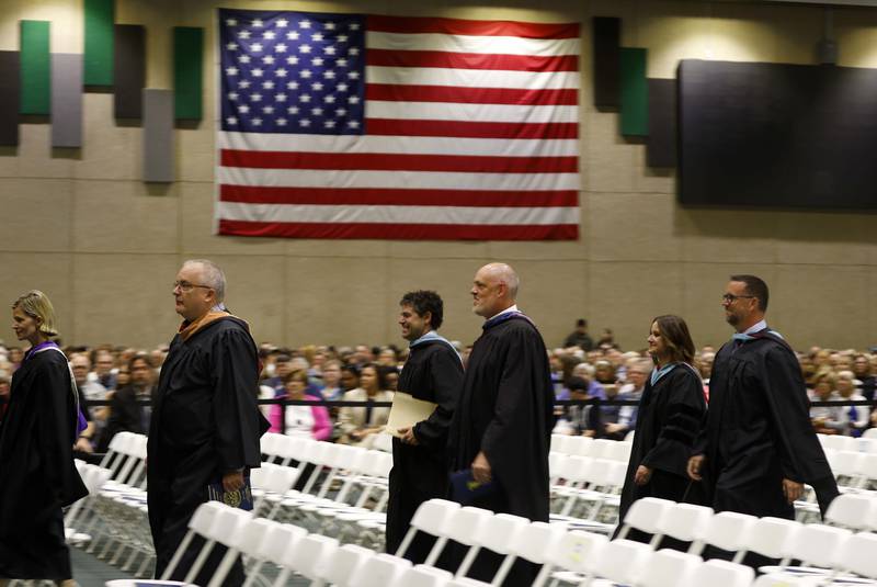 Wheaton North High School faculty and board members stream into the graduation ceremony Saturday, May 25, 2024 in the Physical Education Center of College of DuPage in Glen Ellyn.