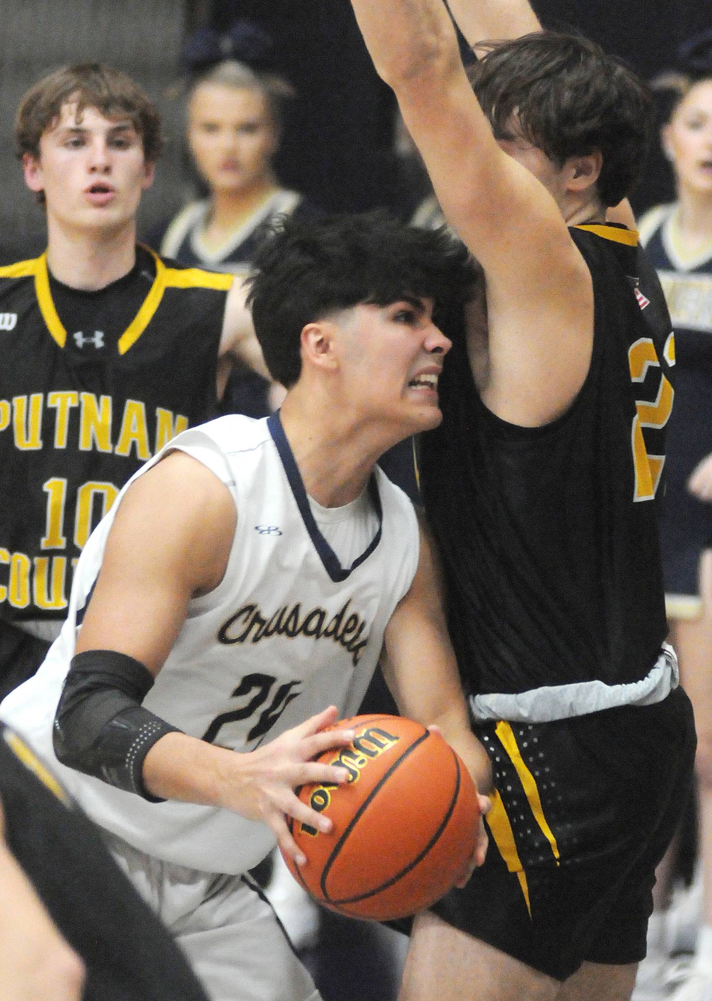 Marquette's Taylor Waldron edges around Putnam County's Orlando Harris at Bader Gymnasium on Friday, Feb. 3, 2023.