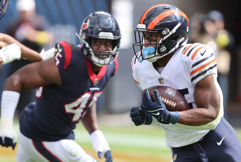 Chicago Bears running back Khalil Herbert gets outside of Houston Texans linebacker Ogbonnia Okoronkwo during their game Sunday, Sept. 25, 2022, at Soldier Field in Chicago.