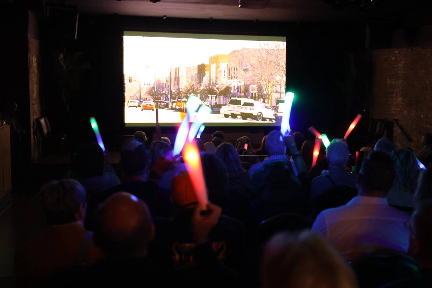 The audience waves glow sticks every time they recognize a place in Lockport during the HBO season 3 premiere of "Somebody Somewhere" at Roxy Lockport on Wednesday, Oct. 30, 2024 in Lockport.