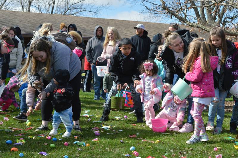 Parents and siblings help kids 2-years-and-under take their turn during Forreston's annual Easter egg hunt in Memorial Park on April 16.