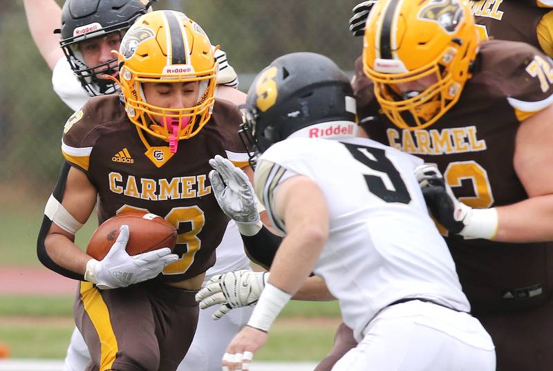 Carmel's Donovan Dey tries to get by Sycamore's Dawson Alexander during their Class 5A second round playoff game Saturday, Nov. 5, 2022, at Carmel Catholic High School in Mundelein.