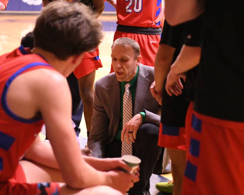 Glenbard South's head coach Jason Mead talks to the team between quarters on Friday Jan. 3, 2025, while traveling to take on West Chicago High School.
