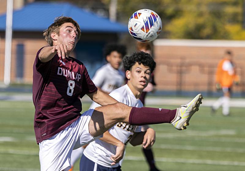 Dunlap’s Tyler Shane works the ball against Sterling’s Ryan Gebhardt Saturday, Oct. 21, 2023 in the regional finals game in Sterling.