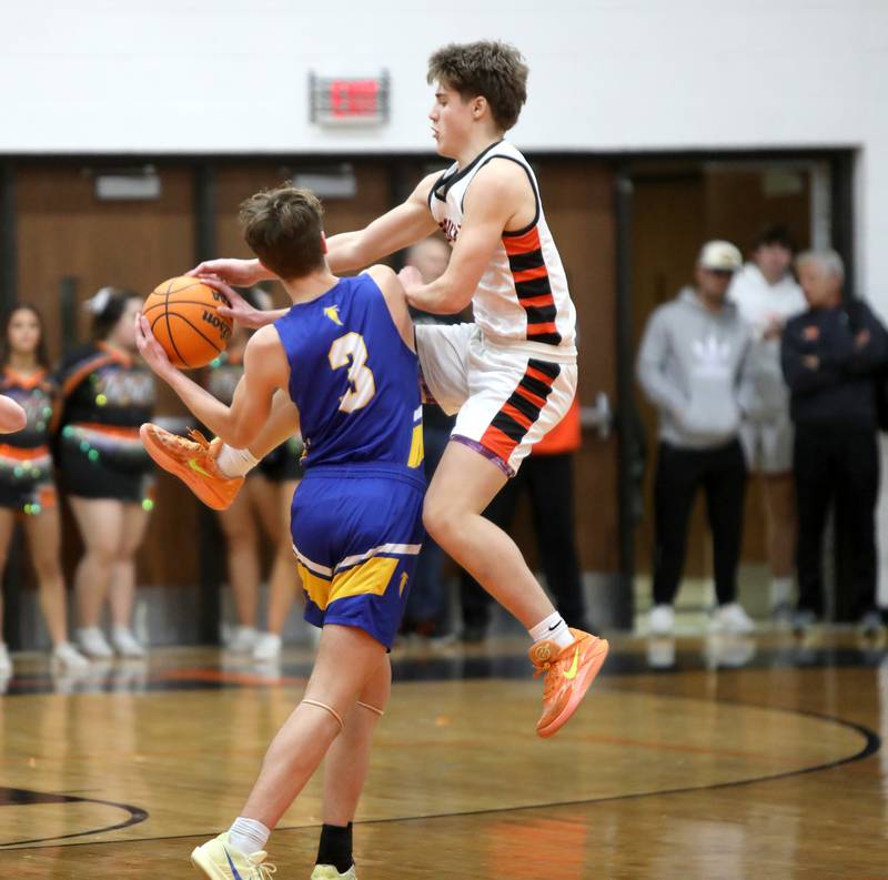 Wheaton North’s Cal MacKay holds onto the ball as Wheaton Warrenville South's Brady McClatchy goes after it during a game on Friday, Feb. 7, 2025 in Wheaton.