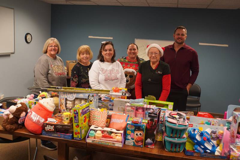 Rochelle Community Action Network board members pose for a photo with toys donated by the community.