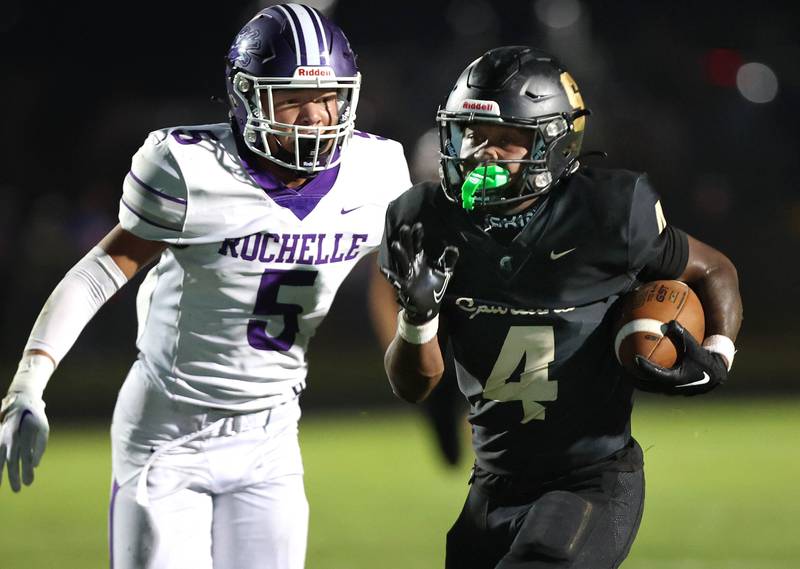Sycamore's Tyler Curtis just beats Rochelle's Elijah Harley to the end zone for a touchdown during their game Friday, Sept. 22, 2023, at Sycamore High School.