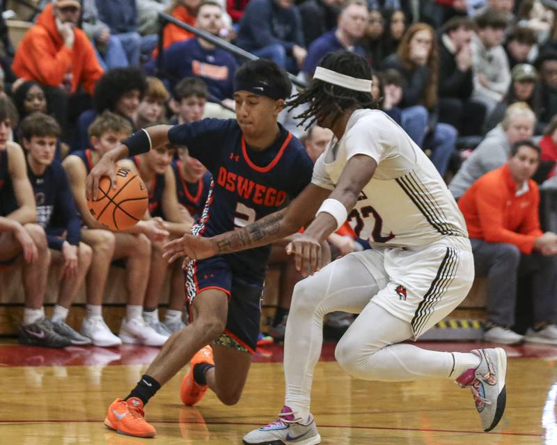 Oswego's Ethan Vahl (3) with a cross over attempt on Yorkville's Braydon Porter (22) during their basketball game between Oswego at Yorkville Friday, Dec 12, 2025 in Yorkville.