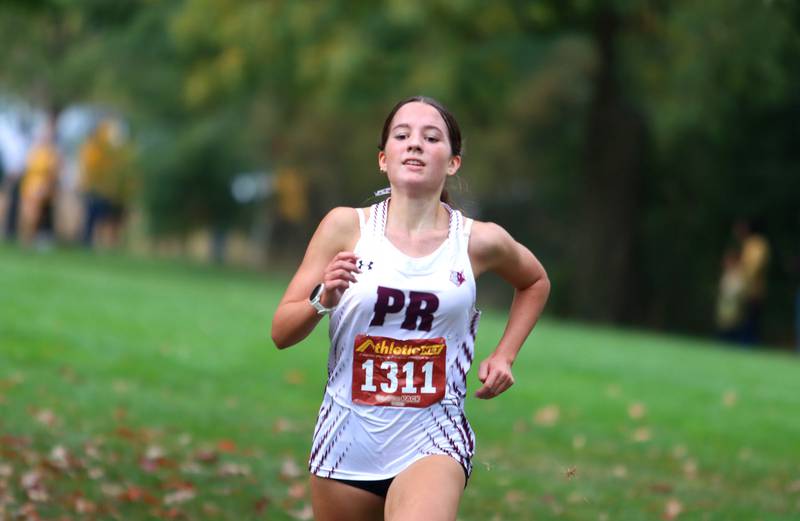 Prairie Ridge’s Emaline Foster wins the Fox Valley Conference Cross Country Meet at McHenry County College in Crystal Lake on Saturday, October. 18, 2025.