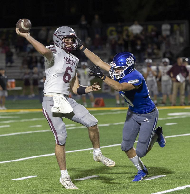 Rockridge’s Cullen Schwigen fires a pass while being chased by Newman’s John Rowzee Friday, Sept. 27, 2024, in Sterling.