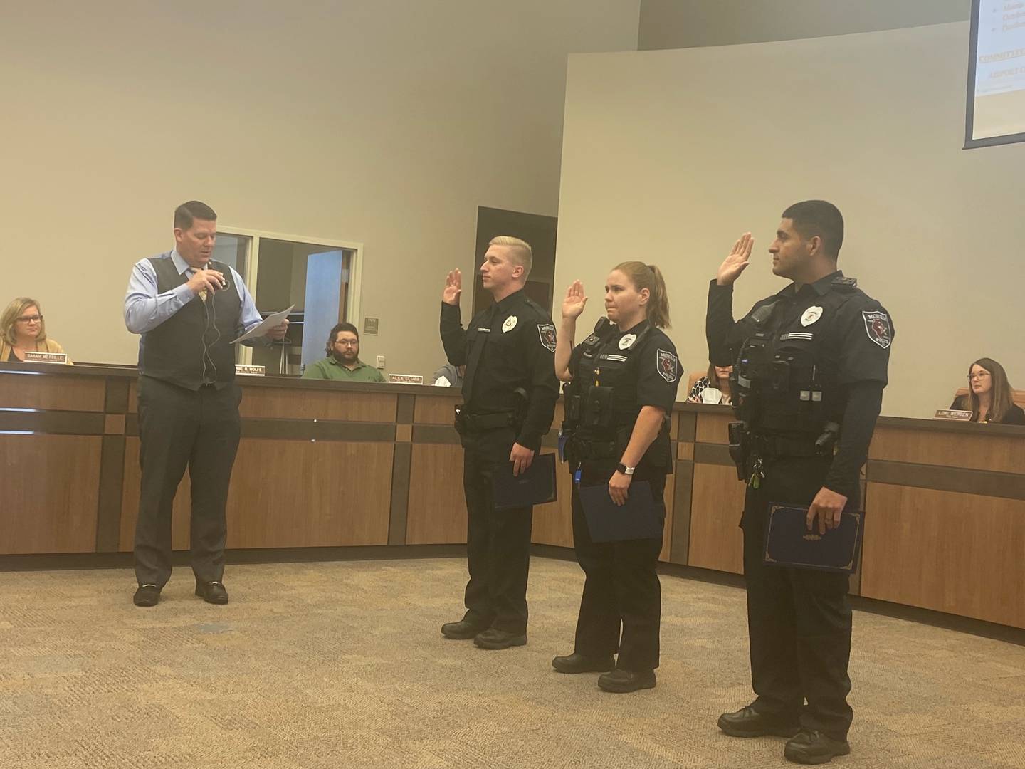 Mayor Chris Brown swears in Officers Trevor Hodge, Anna Schnridewend, and Javier Sanchez.