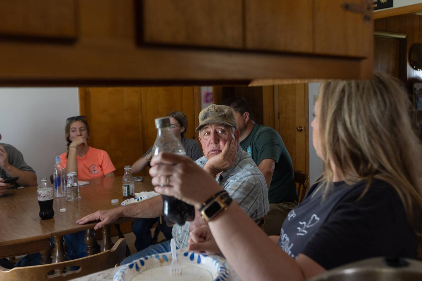 Steve Williams takes a lunch break with his family at his mother’s house on the farm in June.