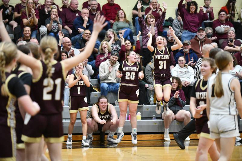Watseka-Milford's Thayren Rigsby (31) and Noelle Schroeder (20) leap in celebration as the Warriors secured a 50-24 victory over Reed-Custer in the IHSA Class 2A Herscher sectional semifinal on Tuesday, Feb. 25.