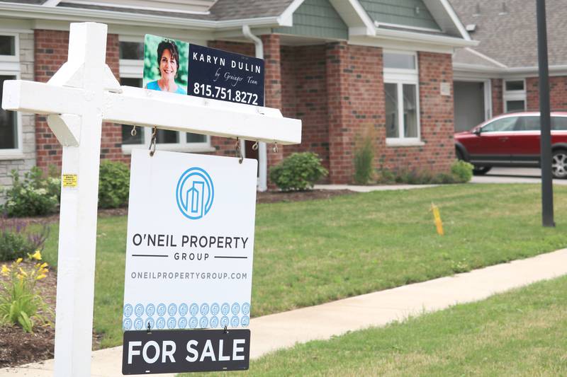 A "For sale" sign sits outside a condo unit at Riverbend Condos in Genoa on Sunday, July 17. The condominium was showed Sunday at an open house hosted by Karyn Dulin of O'Neil Property Group.