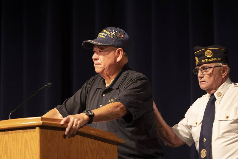 Sterling Veterans Day keynote speaker Ray Torres is comforted by Mike Wolber during his speech on his service in Vietnam. After seeing fierce fighting and attending to wounded Marines, Torres himself was injured ending his service.