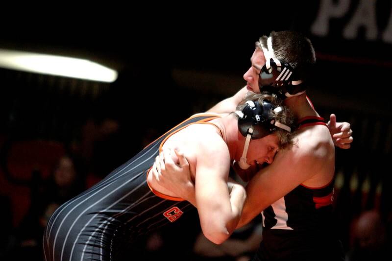 Crystal Lake Central’s Cayden Parks, left, battles Huntley’s Wyatt Theobald in a 190-pound bout in varsity wrestling at Crystal Lake Friday.  Parks won the match.