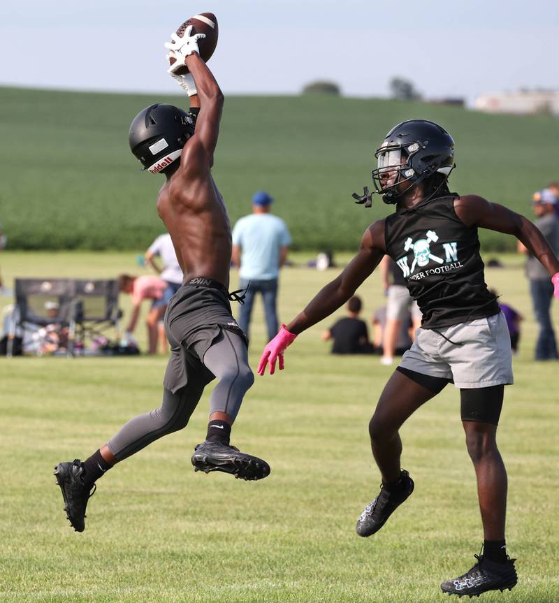 DeKalb’s Derrion Straughter makes a catch in front of a Woodstock North defender Tuesday, July 16, 2024, in the Kaneland 7-on-7 at the school in Maple Park.