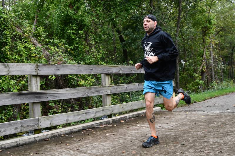 Lockport resident Richard Fague runs along the Wauponsee Glacial Trail in Joliet on Friday, October 15, 2021, in his quest to run 11 virtual 5K races in 11 days as part of the Forest Preserve District of Will County’s “Harvest Hustle” program. The program, which ended Sunday, October 31, 2021 required participants to run only one virtual 5K. Fague is training for ultra-marathons and next year’s Boston Marathon so he increased the challenge for himself.