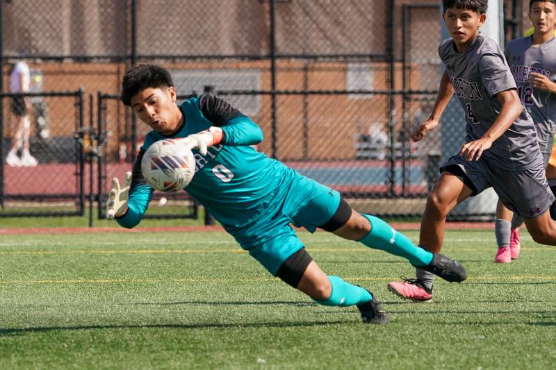Morton’s Miguel Jimenez (0) makes a diving save against Downers Grove South during a soccer match at Morton High School in Berwyn on Saturday, Oct. 5, 2024.