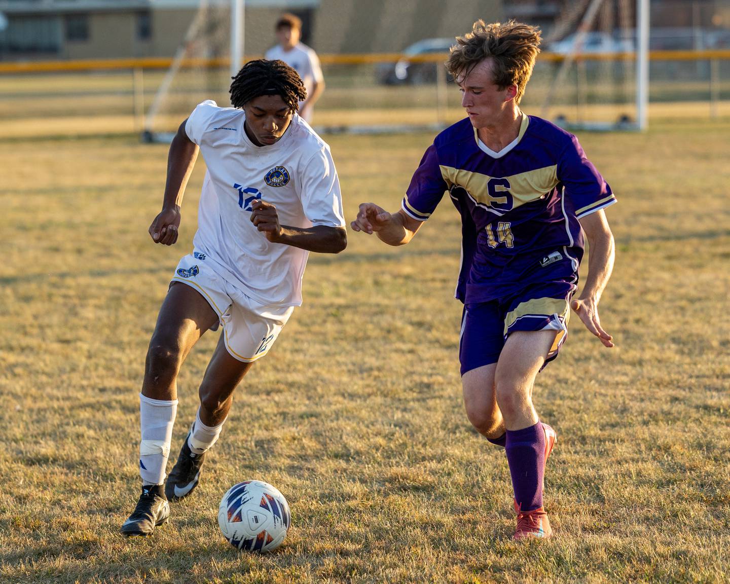 Jackson Brockway (12) of Somonauk/Leland/Newark dribbles ball forward as Caleb Collins (14) of Serena trails on Monday, Sept. 29, 2025, at Serena High School in Serena.