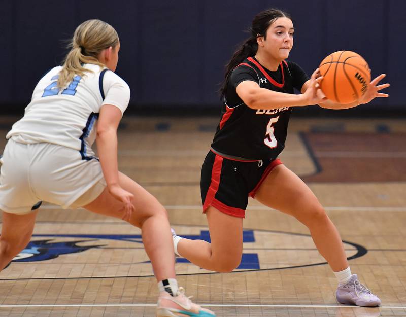 Benet’s Ava Thomas (5) passes the ball as Nazareth’s Lyla Shelton defends during a game on December 13, 2025 at Nazareth Academy in LaGrange Park.