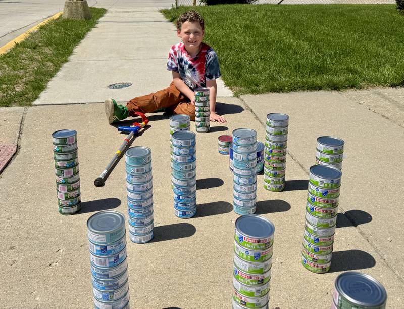 Maximilian Claahsen, of Marseilles, smiles as he collects cans of tuna for his birthday drive on Sunday, April 27, 2025. The cans will be donated to the Marseilles Food Pantry at Marseilles Food Pantry, which is also operated by Max’s mother Carolyn Claahsen, at St. Joseph’s Catholic Church, 200 Broadway St.