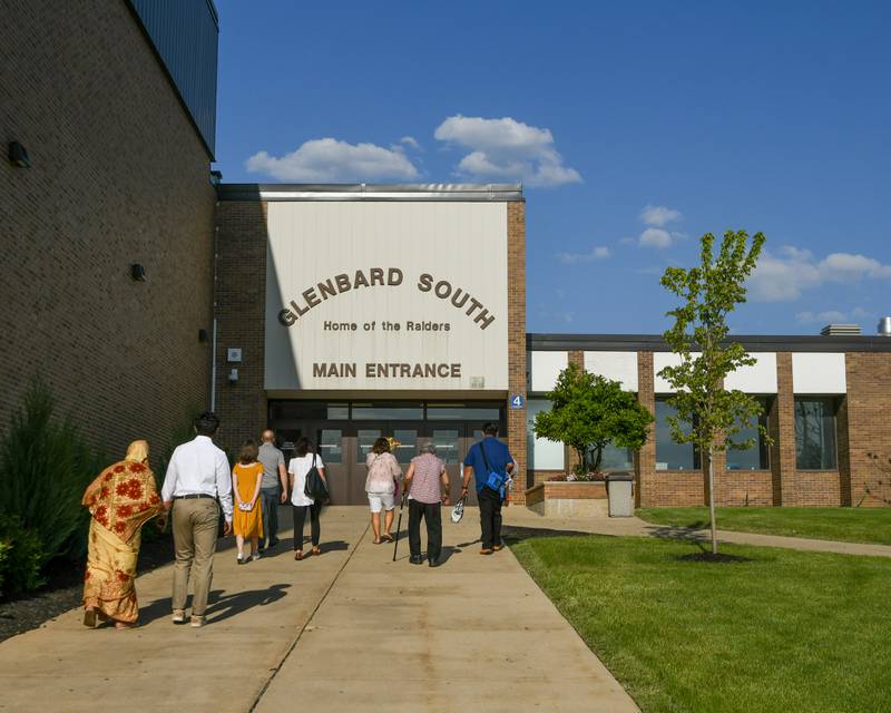 Graduate attendees walk into Glenbard South High School before the start of graduation held on Thursday May 23, 2024.