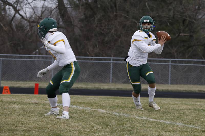 Crystal Lake South’s quarterback Justin Kowalak looks to pass the ball Friday, March 26 during their game at Prairie Ridge.
