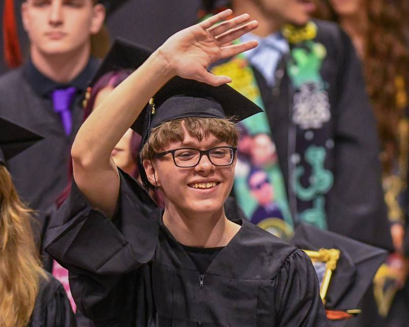 A DeKalb High School senior waves to graduation attendees on Saturday May 23, 2026, as he files into the Convocation Center in DeKalb.