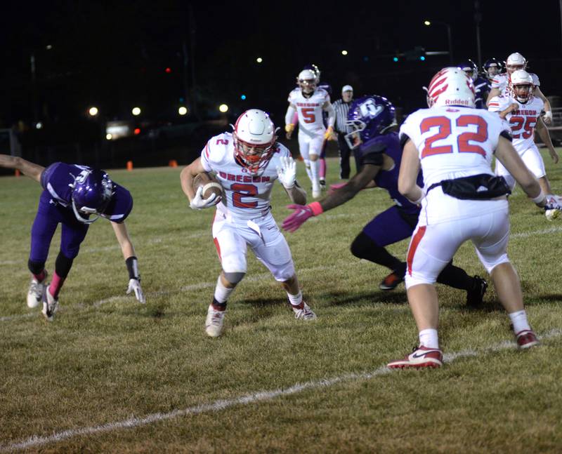 Oregon's Cooper Johnson (2) moves to evade being tackled as Kade Girton (22) looks to block during Friday, Oct. 18, 2024 action against Rockford Lutheran in Rockford.