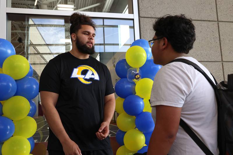 Sophomore Kankakee High School student Juan Velasquez, asks advice of Keagen Trost, a 2019 Kankakee grad, during a celebration held for Trost at the school on May 4, 2026, following him being drafted into the NFL to the Los Angeles Rams.