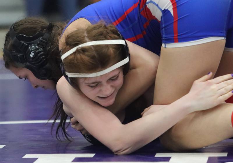 Dundee-Crown’s Zoe Servia, top, battles Hampshire’s Maggie Anderson at 120 pounds in IHSA Regional wrestling action on Saturday, Feb. 1, 2025, at  Hampshire High School  in Hampshire.
