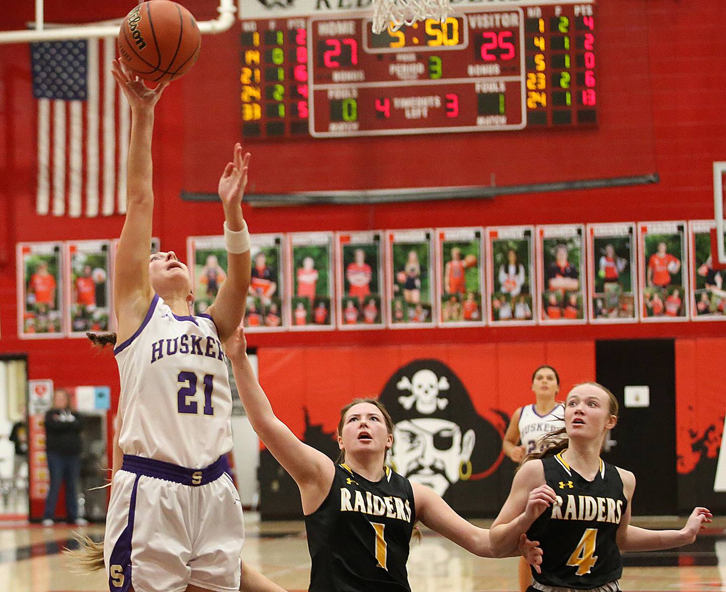 Serena's Makayla McNally lets go of the ball underneath the hoop as Ashton-Franklin Center's Alexis Schwarz defends during the Class 1A Regional final on Thursday, Feb. 15, 2024 at Earlville High School.