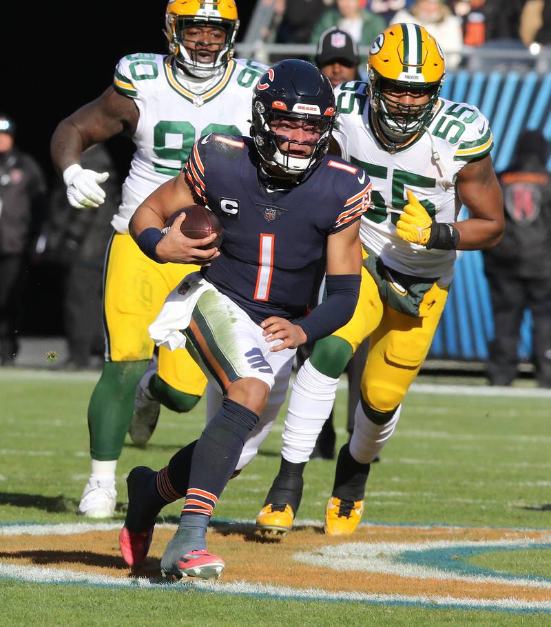Chicago Bears quarterback Justin Fields breaks through the Green Bay Packer defense for a long touchdown run during their game Sunday, Dec. 4, 2022, at Soldier Field in Chicago.
