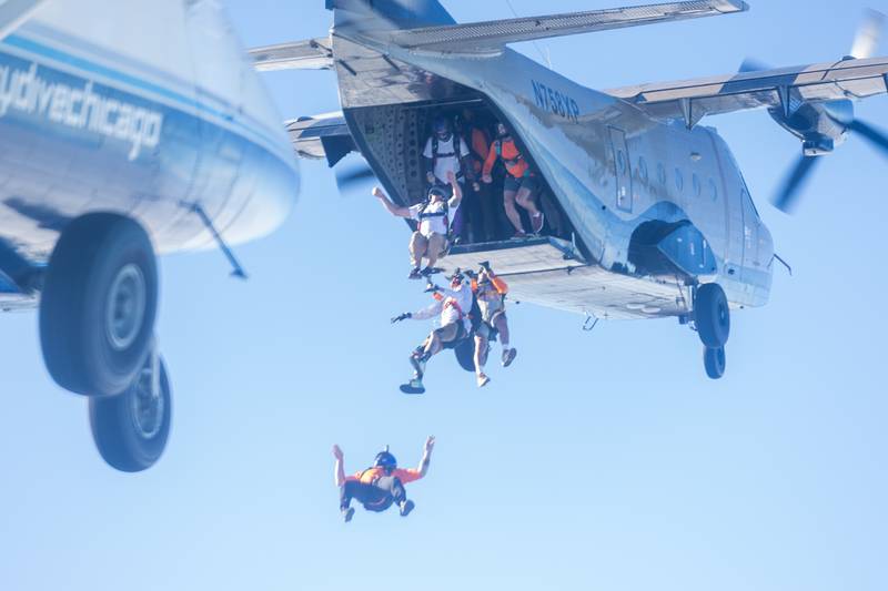 Divers jump out of plane in attempt of the beating state record of most jumpers in belly formation on Wednesday, Aug 20, 2025 above Skydive Chicago in Ottawa.