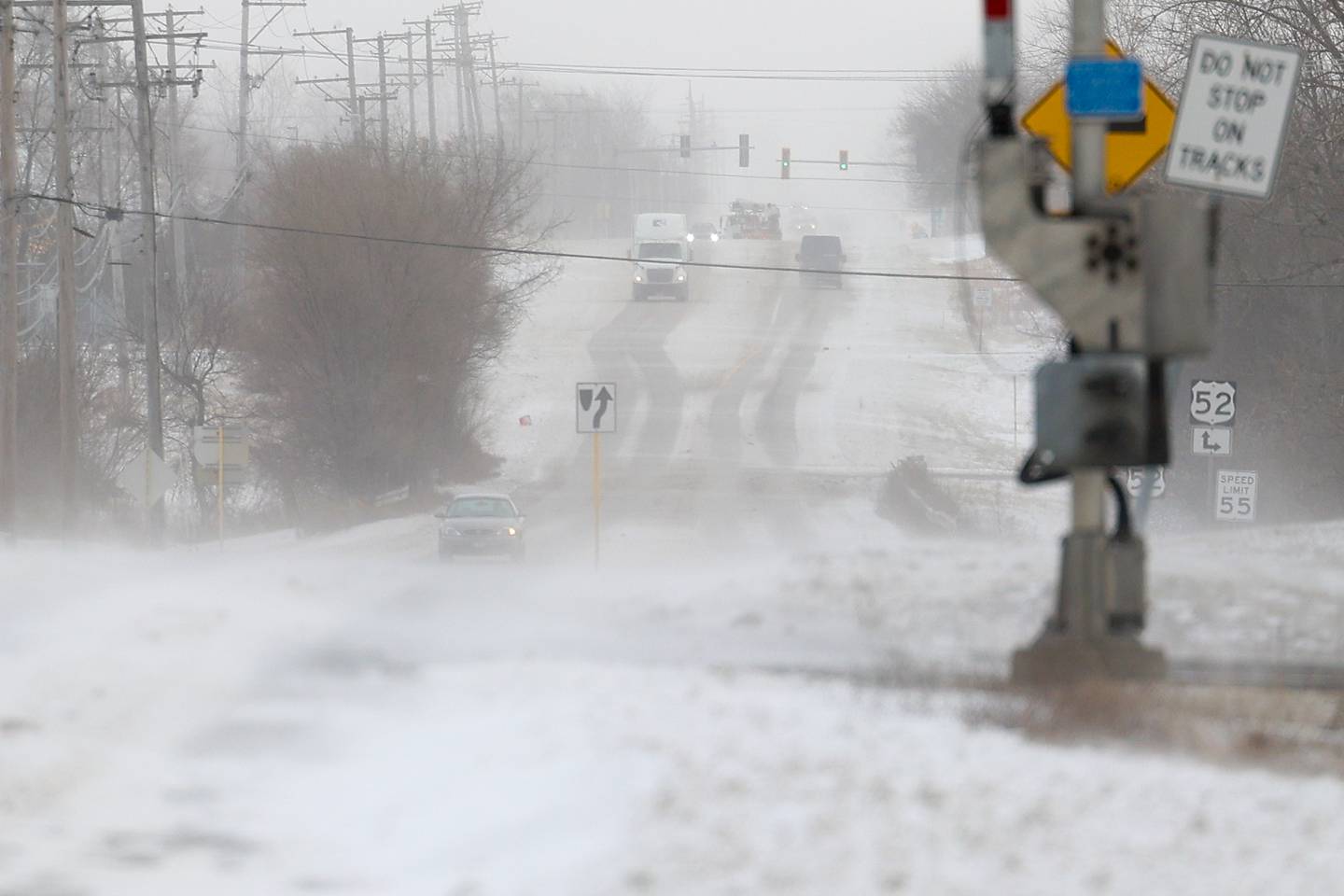 High winds blow snow across South Briggs Street in rural Joliet.