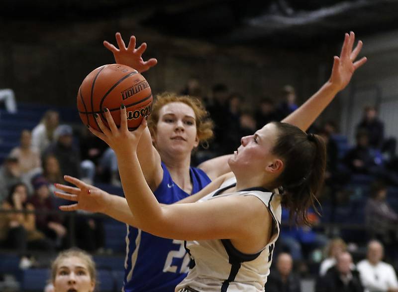 Cary-Grove's Emily Larry drives to the basket against Burlington Central's Paige Greenhagel during a Fox Valley Conference girls basketball game Friday Jan. 6, 2023, at Cary-Grove High School in Cary.