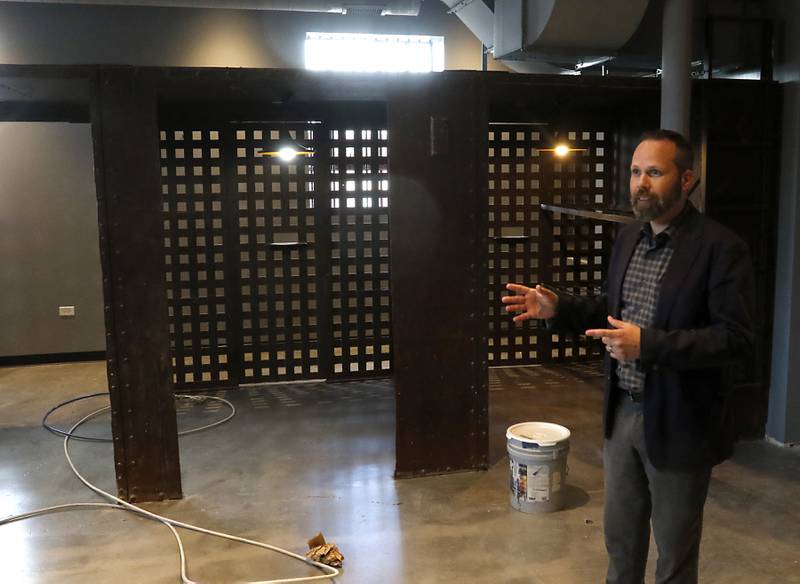 Woodstock City planner Darrell Moore talks about how the old jail cells are being used in the newly remodeled Old Courthouse Center in Woodstock on Thursday, July 13, 2023, during a tour of the building.