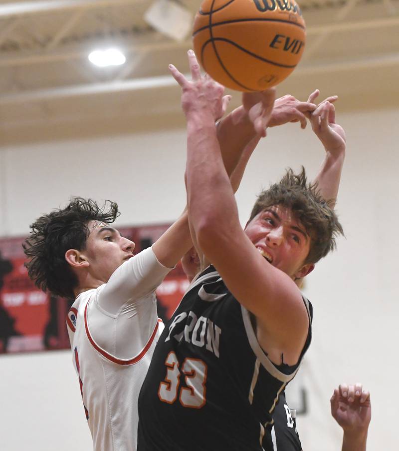 Oregon's Benny Olalde (1) and Byron's Caden Considine (33) battle for a rebound during Monday, Dec. 15, 2025 action at the 64th Forreston Holiday Tournament at Forreston High School.