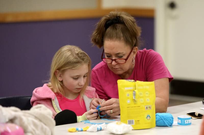 Cheryl Mitzel of Plano and Haley Tutt, 8, work on a crochet project during a session of the Knit and Crochet Group at the Plano Community Library District.