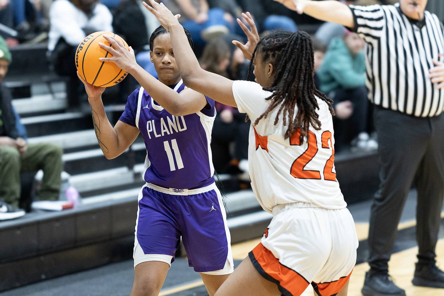 Plano's Jadyn Long (11) looks for an open teammate while being guarded by Sandwich's Alayla Harris (22) during Tuesday's game in Sandwich.