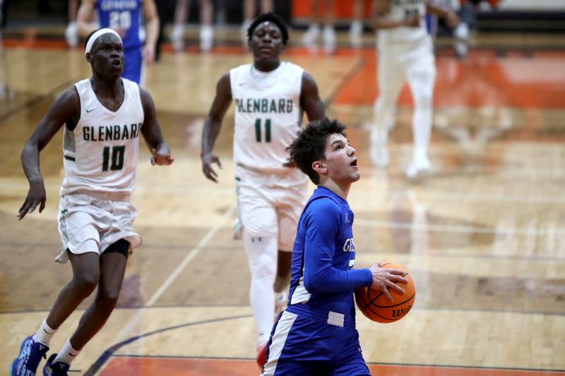 Geneva’s Gabe Jensen goes up for a shot during the Class 4A St. Charles East Sectional final against Glenbard West on Friday, March 7, 2025 in St. Charles.