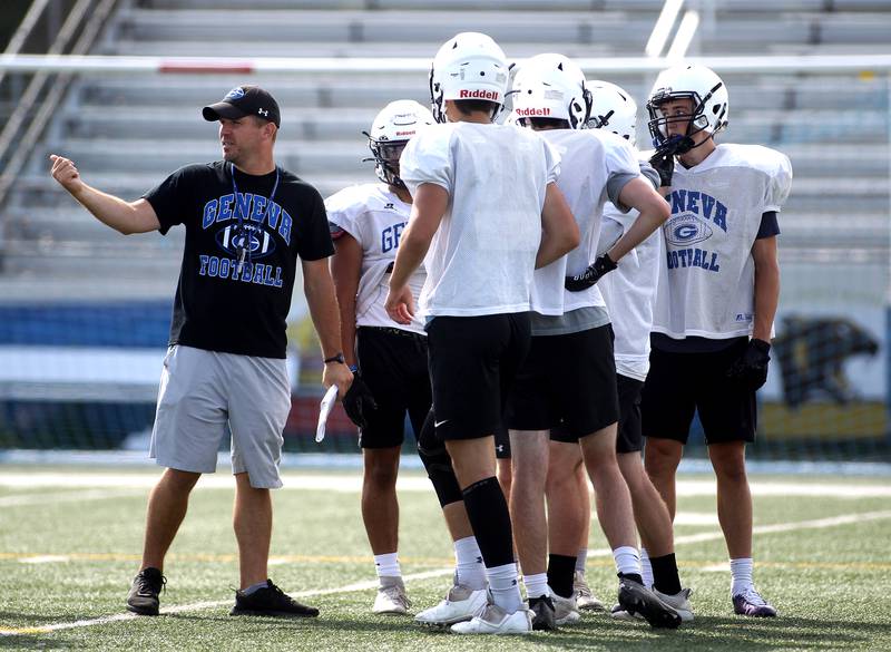 Geneva Head Coach Boone Thorgesen (left) talks to members of his team during a practice session at the school on Friday, July 9, 2021.