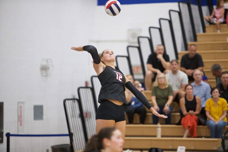 Benet's Lynney Tarnow serves a ball against St. Charles North on Monday, Oct. 6, 2025 in St. Charles.