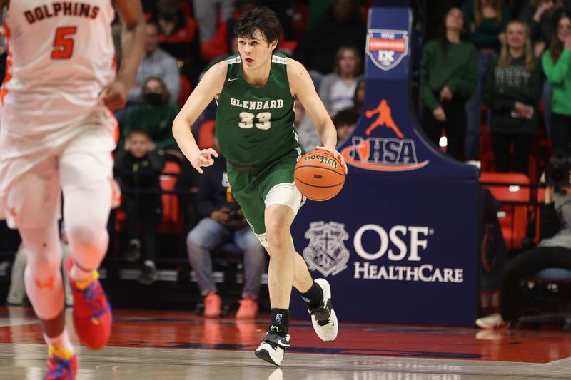 Glenbard West’s Bobby Durkin takes the ball up court against Whitney Young in the Class 4A championship game at State Farm Center in Champaign. Saturday, Mar. 12, 2022, in Champaign.