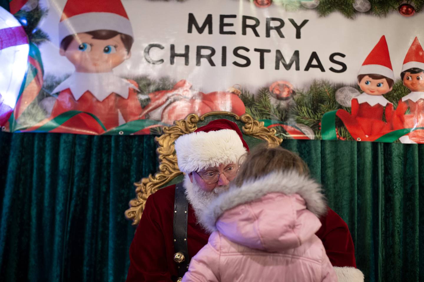 Santa Claus finds out what a little girl wants for Christmas at the Kankakee Train Depot on Thursday, December 4, 2025.