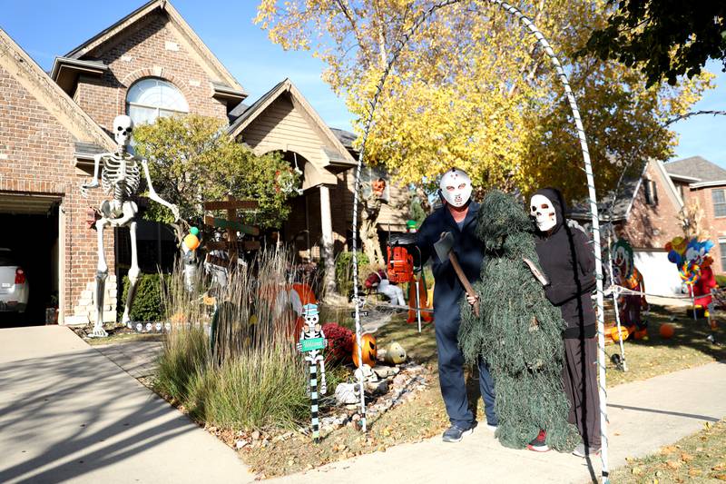 Mark Licht (left), son Noah, 10, (center) and wife, Laura (right), are in their sixth year of competing in the St. Charles Park District Halloween decorating competition at their home, which is located in the Thornwood subdivision in South Elgin.