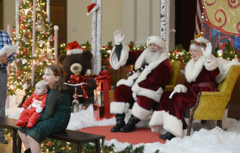 Children including Natalija and Christian Bojovic of La Grange take pictures with Santa and Mrs. Clause during the La Grange Christmas celebration held Saturday Dec. 4, 2021.