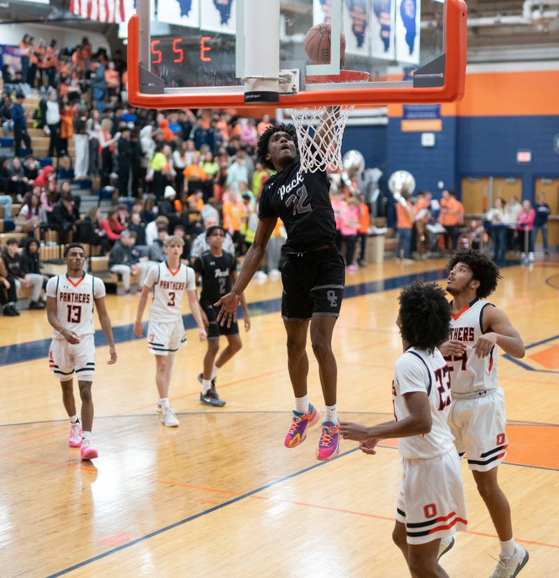 Oswego East's Jehvion Starwood (22) dunks the basketball against Oswego during a basketball game at Oswego High School on Tuesday, Dec 12, 2023.
