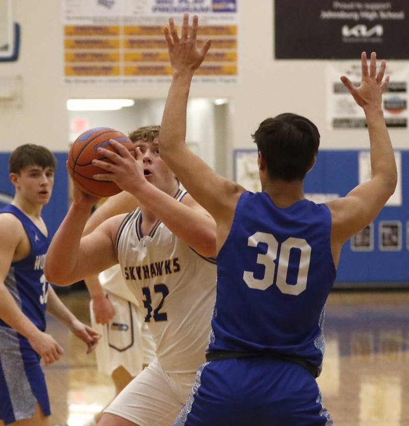 Johnsburg's Jacob Welch eyes the basket over Woodstock’s Spencer Cullum during a Kishwaukee River Conference boys basketball game Tuesday, Jan. 31, 2023, at Johnsburg High School.